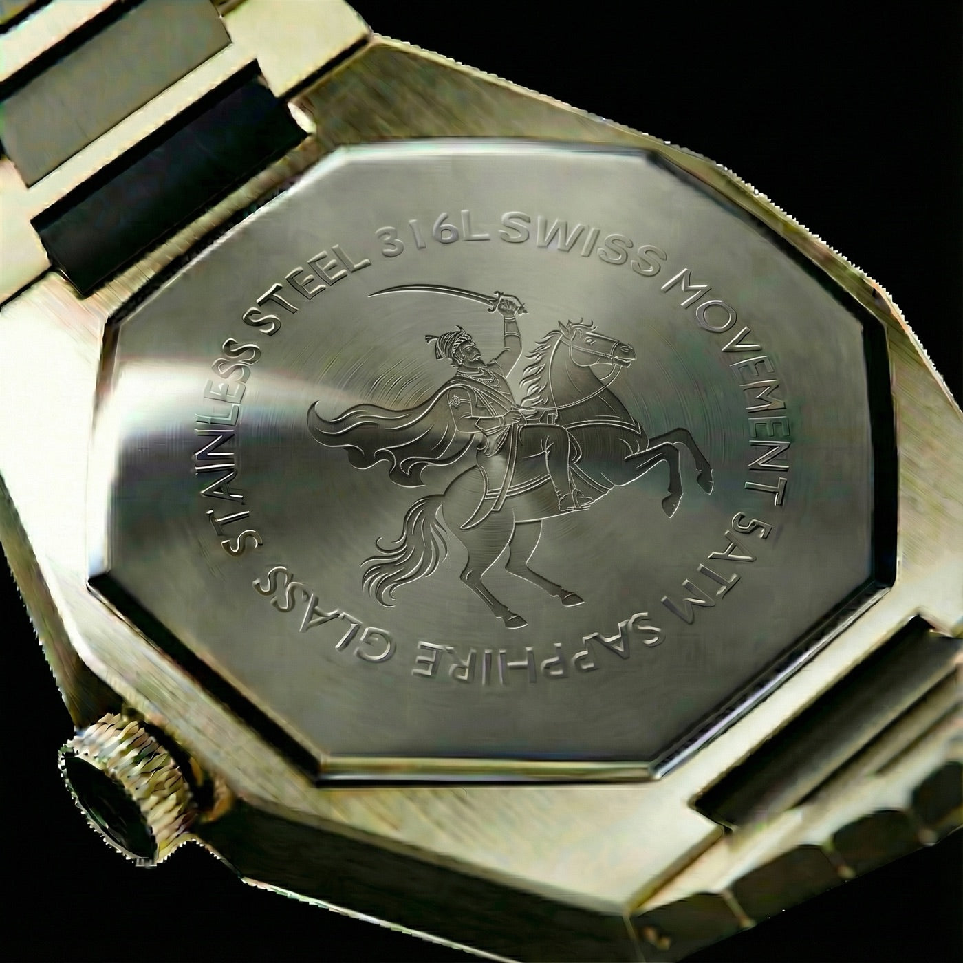 Pride of Maharashtra black/gold caseback macro showing Shivaji Maharaj emblem engraved in surgical steel